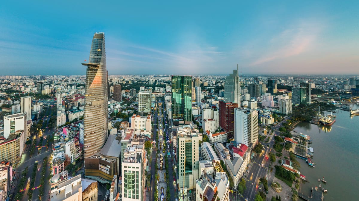 Aerial view of Ho Chi Minh City's District 1 skyline with the Bitexco Financial Tower and the Saigon River