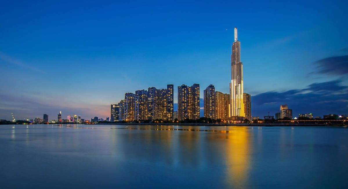 Ho Chi Minh City skyline at blue hour, with Landmark 81 lit up and reflected in the Saigon River
