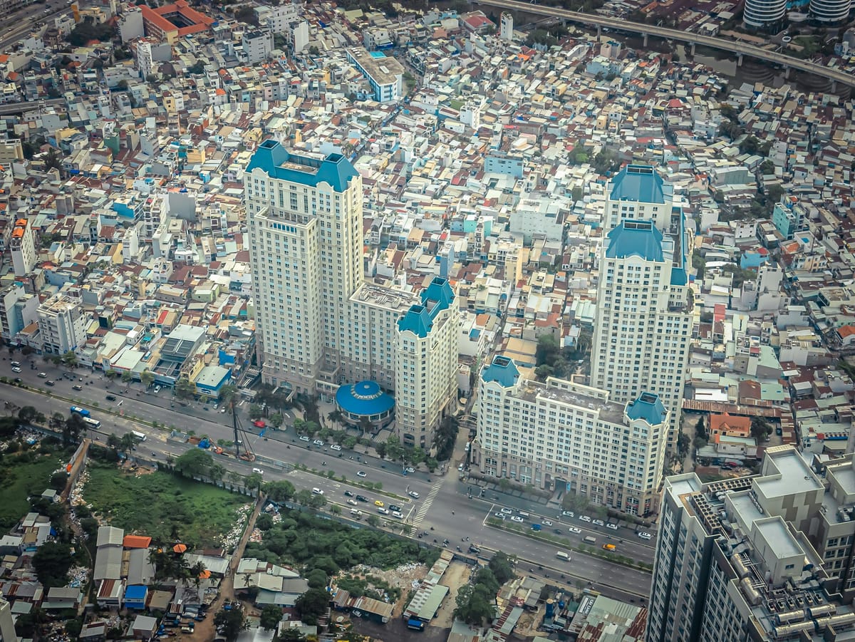 Aerial view of Ho Chi Minh City, with commercial apartment towers rising out of a sea of low-rise houses